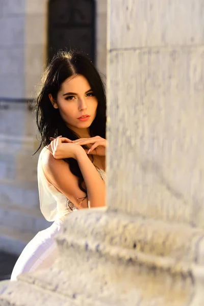 Bride girl at wedding ceremony in castle. Sexy girl in white dress with stylish hair. Wedding fashion and beauty salon. Woman at stone ancient column in summer. Fashion model or princess in dress. — Stock Photo, Image