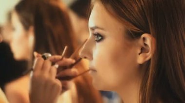 Makyaj sanatçısı için çekici bir genç kadın makyaj uygulamak. Makyaj genç kız için. Genç kız Güzellik Salonu.