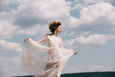 Yaz aylarında güneşli mavi gökyüzü arka plan kız. Güzel kız beyaz gelinlik ve retro saç modeli. Moda kadın model poz açık. Güzellik ve moda vintage tarzı bak. Genç yüz makyaj.