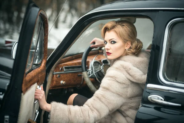 Escort and security guard for luxury woman. sexy woman in fur coat. Call girl in vintage car. Retro collection car and auto repair by driver. Travel and business trip or hitch hiking.