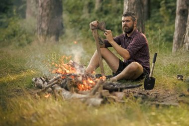 Sakallı adam oduncu balta şenlik ateşi, keskinleştirmek