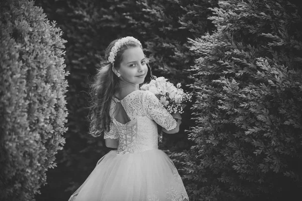 Little bridesmaid standing in a park — Stock Photo, Image