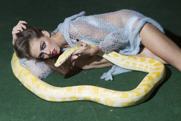 Hermosa mujer morena sosteniendo serpiente pitón, tentación — Foto de Stock