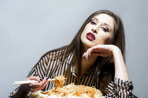 Menina com fome tem comida italiana refeição. Mulher com fome comer espaguete com pauzinhos — Fotografia de Stock