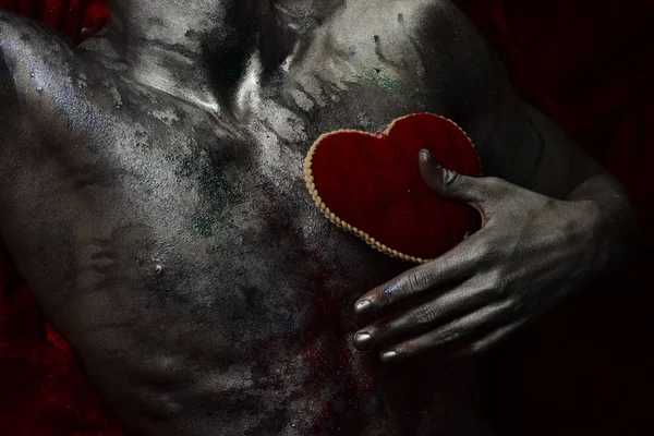 Torso desnudo con peluche rojo suave corazón juguete, fondo oscuro . — Foto de Stock