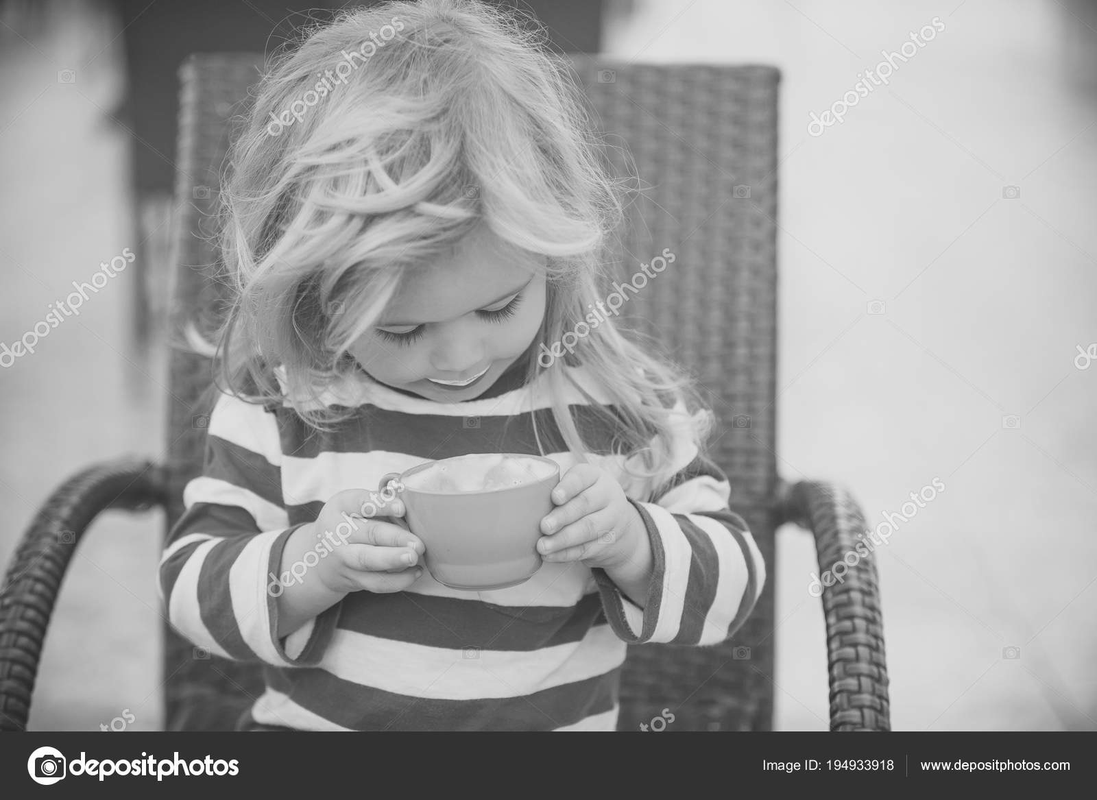Boy drinking milk on chair Stock Photo by © 194933918