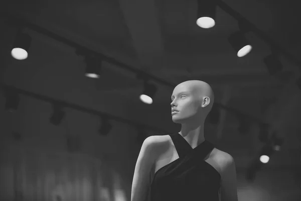 Mannequin en vêtements à la mode sur fond gris avec des lustres élégants. Concept shopping et boutique. Poupée de luxe à la mode. Mannequin en plastique blanc avec robe noire . — Photo