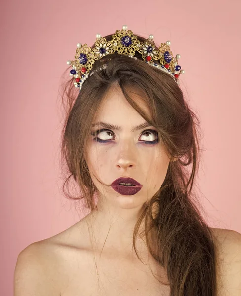 Emotional queen with crazy face and fashionable makeup in crown. Surprised queen with trendy makeup.