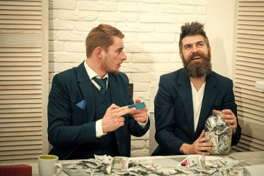 Sakallı patron kavanoz dolusu para tutar, meslektaşım kredi kartı almıştır. İş kar, kavanoz veya banka hesabı para tutmak. Para ve bankacılık kavramı. İş ortakları, office toplantıda işadamları