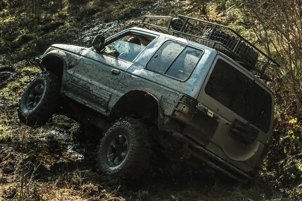 Offroad araba çamura güneşli sonbahar gününde sıkışmış. — Stok fotoğraf