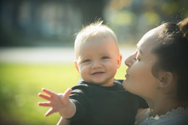 Mom and baby boy outdoor. Mother hug little son with love. Woman with child. Mothers day concept. Happy family enjoy sunny day. Love care and trust — Stock Photo, Image