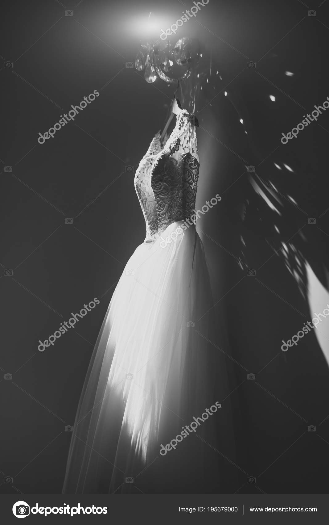 Beauty And Fashion Wedding Dress Hanging At Beautiful Lamp