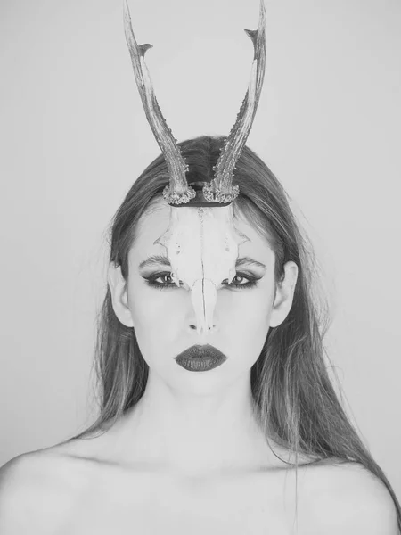 Fashion devil of mystic shaman girl with horns. Woman with makeup and antlers. Beauty look and cosmetics for skincare. Dark fantasy creature elf on halloween in skull. Chinese Horoscope and goat year. — Stock Photo, Image