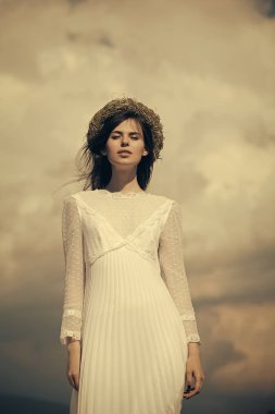 Bulutlu gökyüzü üzerinde poz kadın