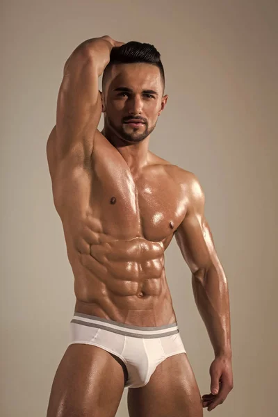 Αθλητική bodybuilder άνθρωπος σε γκρίζο φόντο. — Φωτογραφία Αρχείου