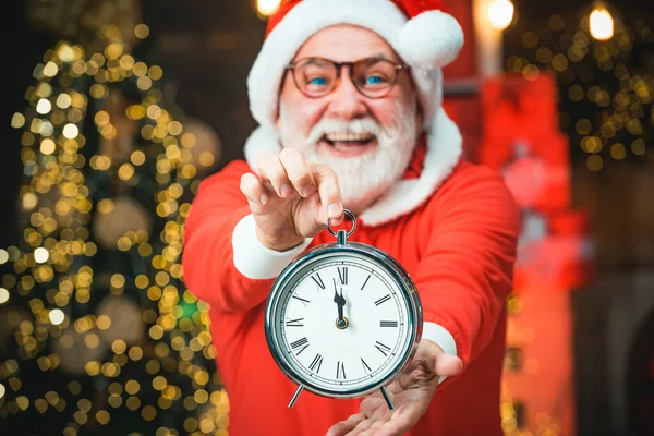 Porträt des Weihnachtsmannes mit Wecker. Frohes neues Jahr. Foto der Standuhr des Weihnachtsmannes, die fünf Minuten vor Mitternacht zeigt. — Stockfoto