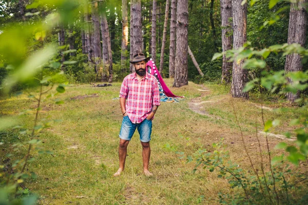 Natural background. Bearded man relax in forest. Mature hipster with beard. Guy in forest. Summer camping. Serious bearded man. — Stock Photo, Image