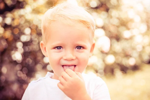 Kleine jongen geniet van het leven en de natuur. Kind buiten in de natuur. Jongen schattig speels vrolijk kind grappig grimas gezicht. — Stockfoto