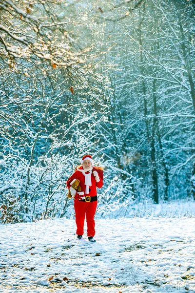 Santa Claus tirando de una enorme bolsa de regalos sobre fondo blanco de la naturaleza. Entrega regalos de Navidad. Tarjeta de felicitación de Navidad de invierno. Santa Claus con bolsa grande. —  Fotos de Stock