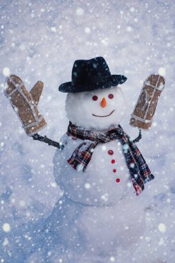 Kış tatilin kutlu olsun. Beyaz karlı arka planda Noel Kardan Adam. Noel 'de parlak yıldızlı kardan adam.