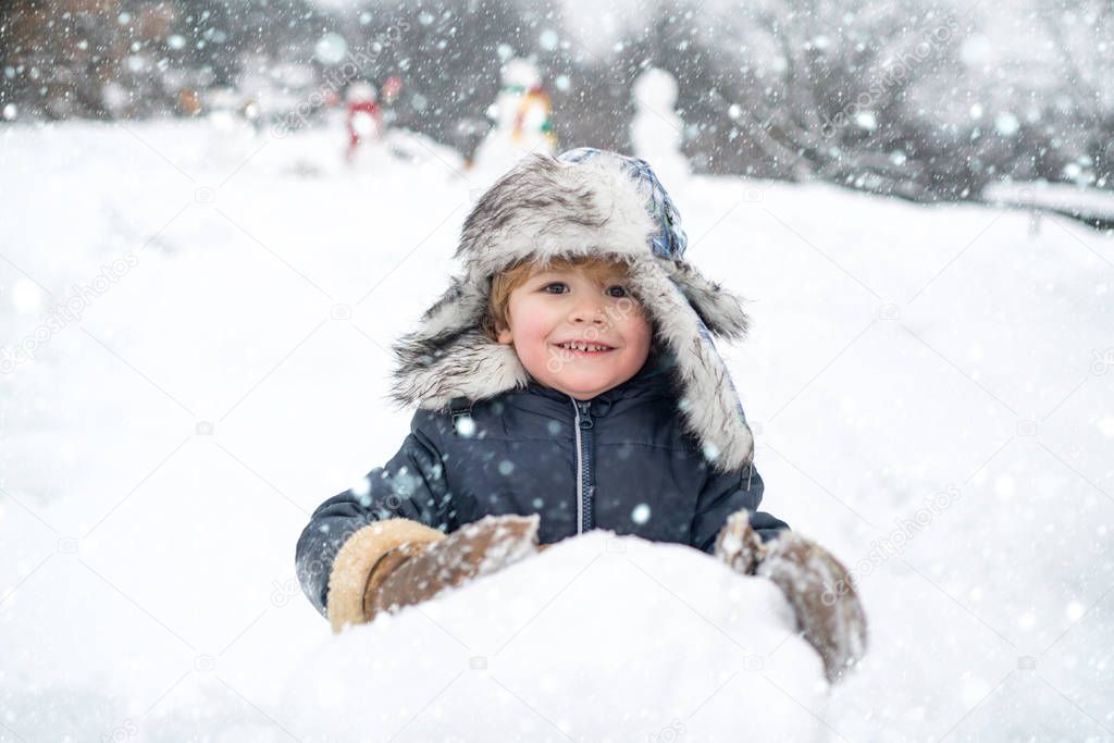 Happy kid winter portrait. Kids in snow. Merry Christmas and Happy new year. Winter kid. Winter morning. Winter emotion.