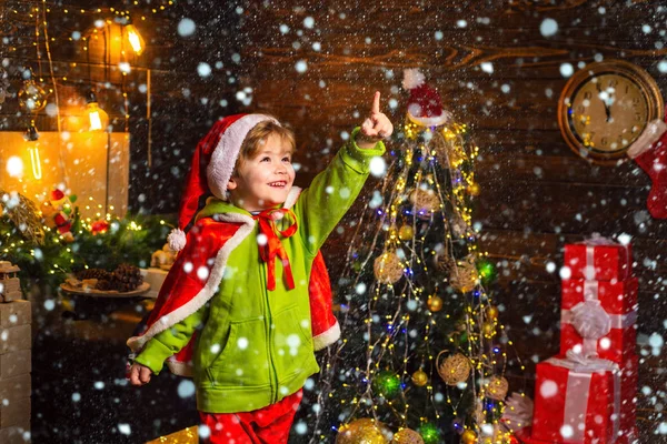 Christmas childs in snow. Home filled with joy and love. Best wishes for you your family this christmas. Merry christmas and happy new year. Cute little child boy play near christmas tree. Kid enjoy — Stock Photo, Image
