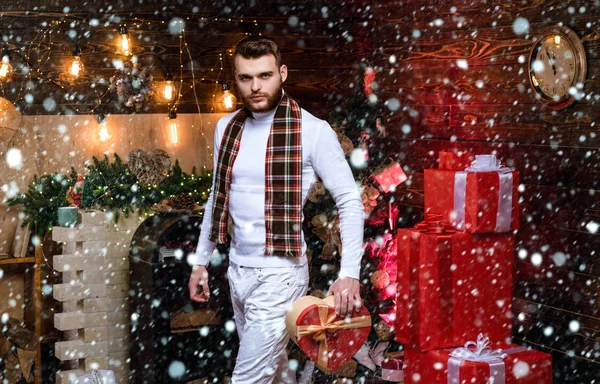 Christmas man in snow. Handsome man with gift box surprise waiting midnight. Happy holiday. Gift card concept. Happy new year. Christmas eve. Home. Christmas gifts. Christmas celebration traditions.
