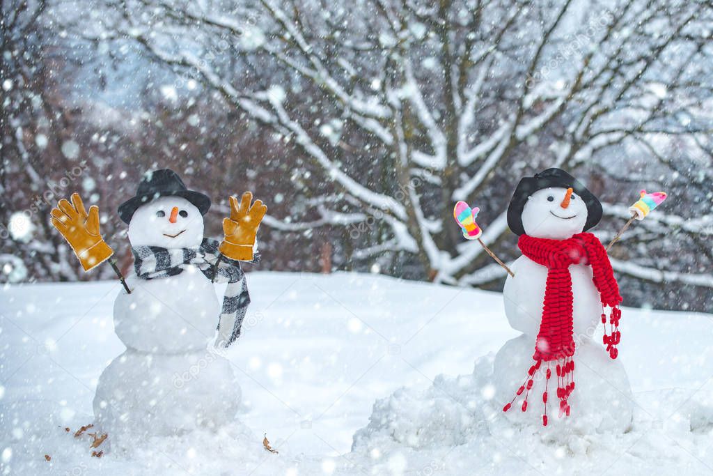 Funny snowmen. Winter scene with snowman on white snow background. I love you. Enjoying nice weekend together.