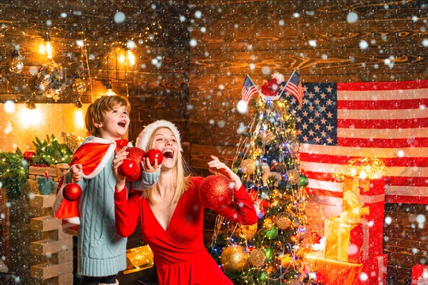 Woman in snow. Happy family. Family holiday. Mom and kid decorating together christmas tree. Mother and son friendly having fun. Enjoy every moment together. Cozy evening at home. Family having fun at — Stock Photo, Image