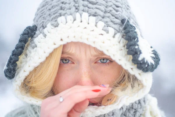 Retrato de una mujer joven con gripe y sonándose la nariz. Mujer joven con limpiaparabrisas cerca del árbol de invierno. Mujer con servilleta estornudando en el parque nevado de invierno . —  Fotos de Stock