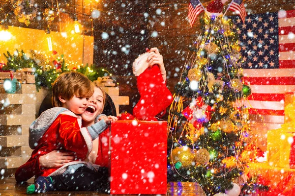 Family having fun at home christmas tree. Family holiday. Happy family. Mom and kid play together christmas eve. Mother and little child boy adorable friendly family having fun. My dear baby santa