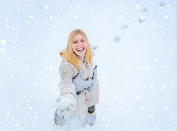 雪の中の少女白い雪の上を歩く若い美しい幸せな笑顔の女の子の屋外写真背景。初雪を楽しむ美人. — ストック写真