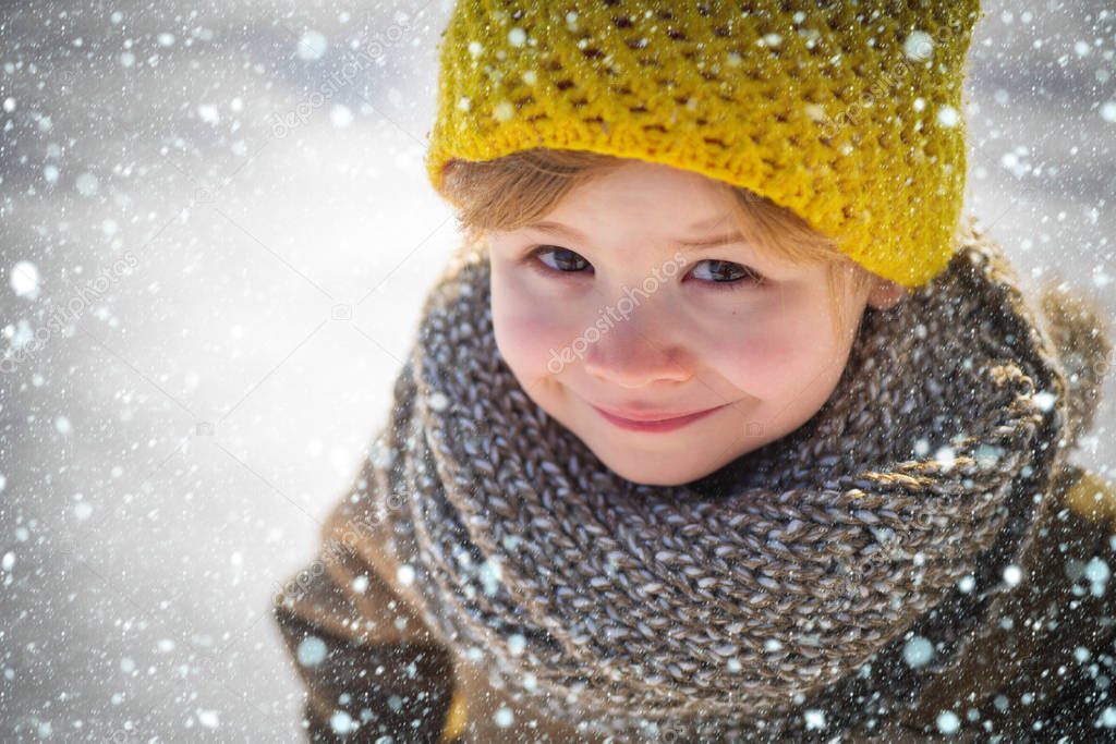Portrait of cute little boy in winter outdoor. Cold and travel winter tourism active holidays in December, January and February. Amazing winter park.