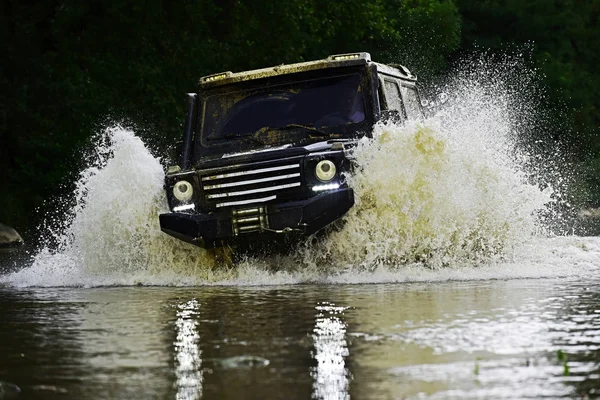 Off road sport truck between mountains landscape. Track on mud. 4x4 Off-road suv car. Offroad car. Safari. Rally racing.