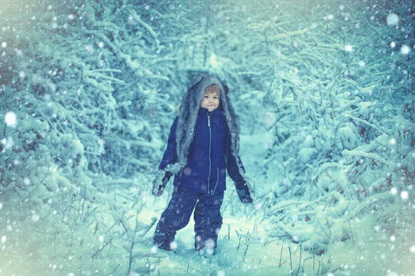 Zimní sněhová modř. Zima na venkově. Zimní oblečení pro děti. Dítě si hraje na zasněženém poli v zimním lese. Koncept dětské vlídnosti v zimě a dětství. — Stock fotografie