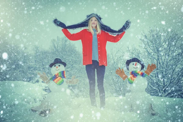 Vintersnöblått tonat. Glad vinter flicka gör snögubbe. Julen glada människor utomhus. Kvinna Göra snögubbe och ha vinter kul. — Stockfoto