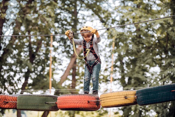 Early childhood development. Children fun. Go Ape Adventure. Children summer activities. Toddler age. Child concept. Adventure climbing high wire park. — Stock Photo, Image
