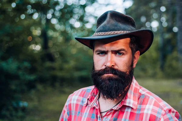 Hipster tourist explore forest. Fashion portrait man. Human and nature. Hispter style. Handsome strong stylish man with long lush black beard and moustache. Masculinity and brutality concept. — Stock Photo, Image