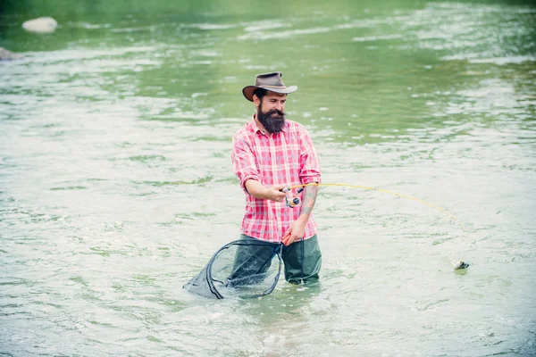 Bearded son. Fishing on the lake. Man enjoy peaceful idyllic landscape while fishing. Man in shirts fishing at morning on the lake. Hobby and sport activity. Hobby for soul. — Stock Photo, Image