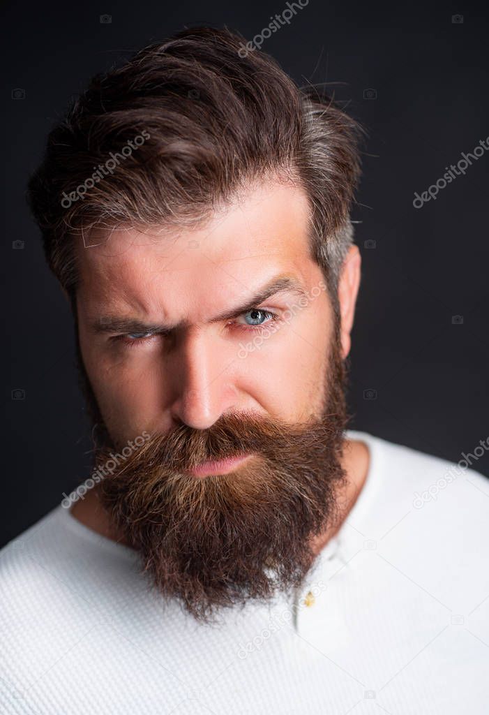 Close-up face of bearded man on black background - professional studio light. Portrait of adult man of Caucasian appearance isolated on black background.