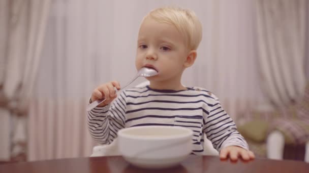 Glad baby äta gröt med sked Söt baby äta. — Stockvideo