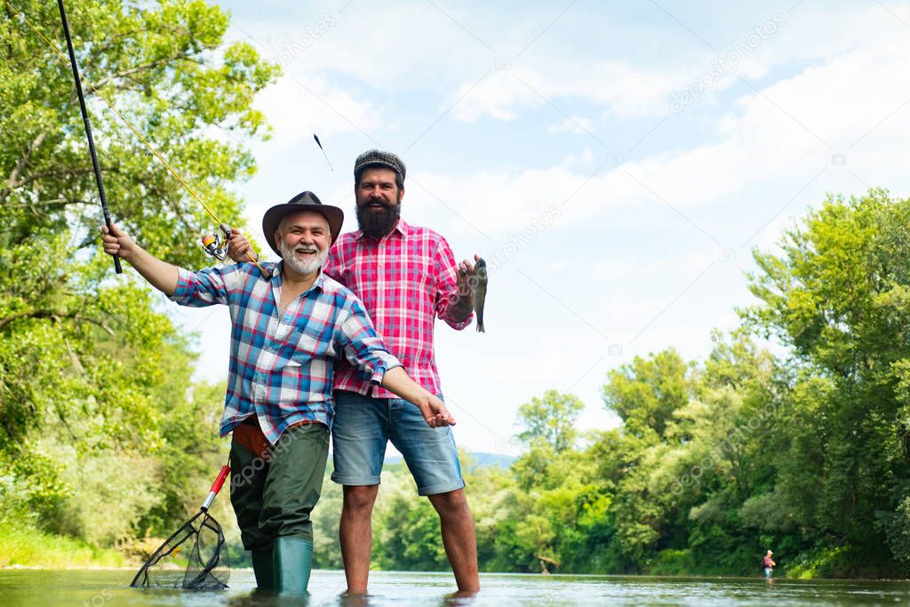 Elegant bearded man and brutal hipster fishing. Cheerful mature fisherman fishing in a river outdoors. Fishing freshwater lake pond river. I am retired.