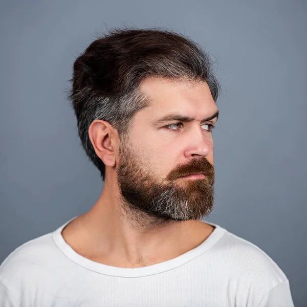 Sexy, prachtige, stijlvolle man. Close-up portret van een knappe jongeman. Portret van een knappe man tegen een grijze muur. — Stockfoto