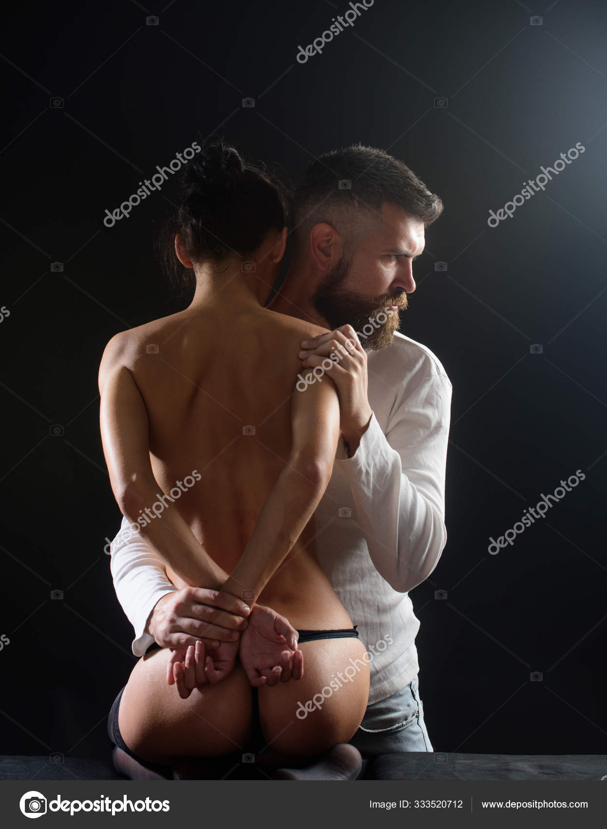 Adorable woman and handsome bearded man foreplay before sex. Couple full of desire. Lover sexy naked female body foreplay with photo