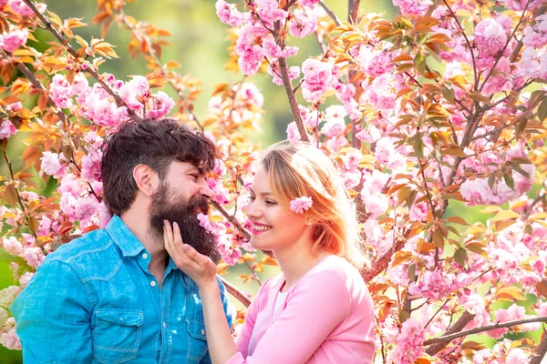 I Love You. Tender love feelings. Loving man and woman on a walk in a spring blooming park. True love. Spring couple laughing and hugging. Happy Valentines Day.