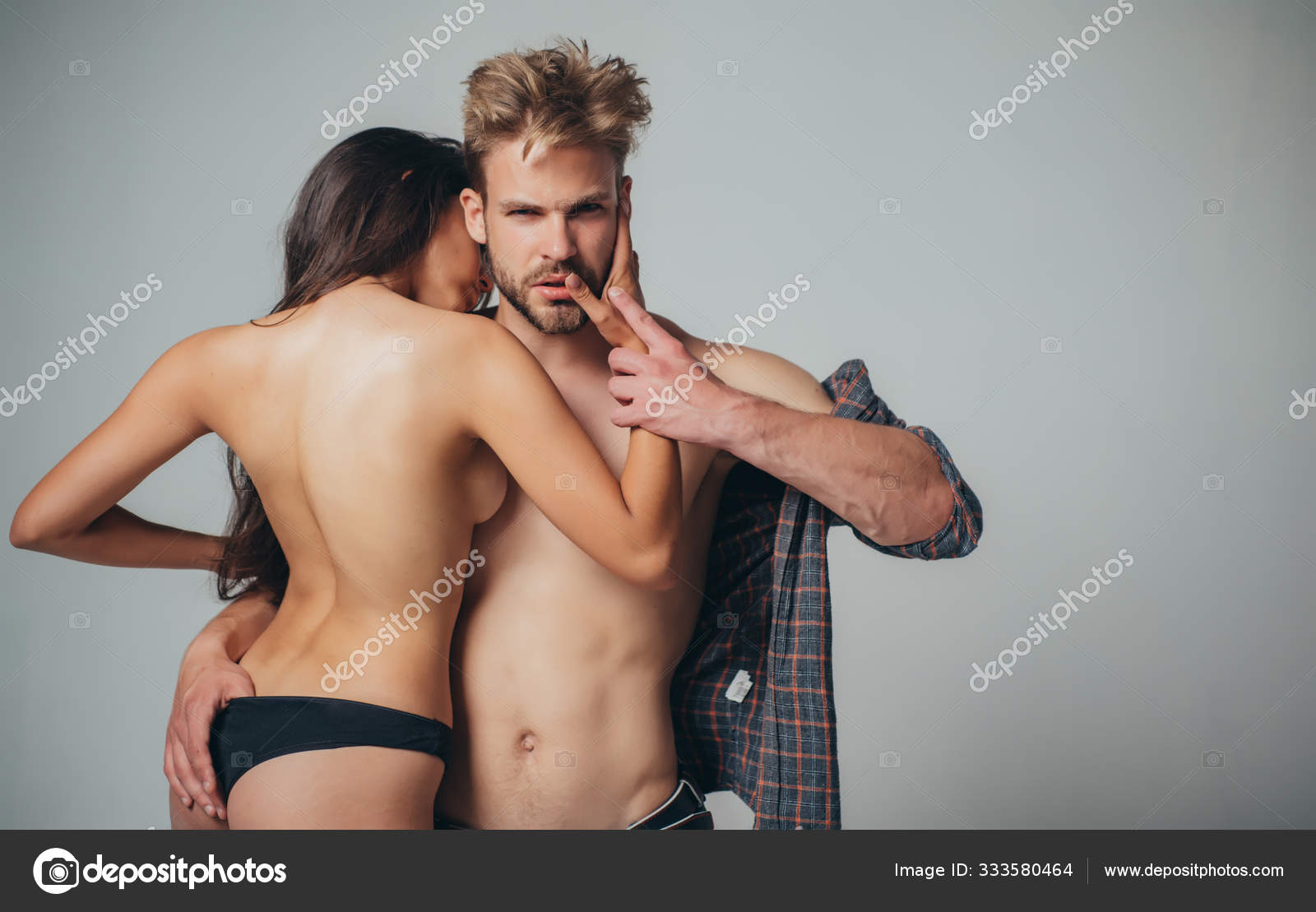 Bearded dominating man embrace his sexy topless hot girlfriend with nice fit ass. Couple in love foreplay and sex fetishist games photo