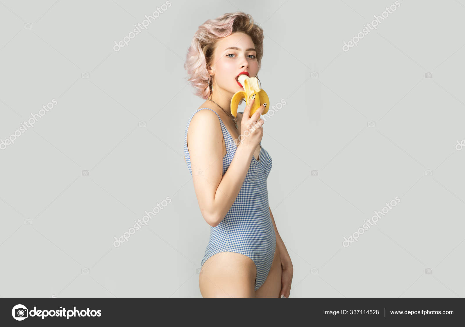 Cute Girl Eating A Banana Beautiful Young Woman In Blue Beachwear