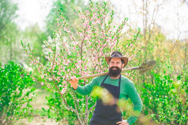 Gardener work in yard with garden tools and have good time. — Stock Photo, Image