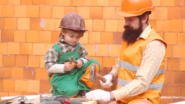 Father and son - Childhood concept. Father and son - Childhood concept. Concept of partnership. Child and works. Little boy dreaming about a new home. Little child builder. — Stock Video