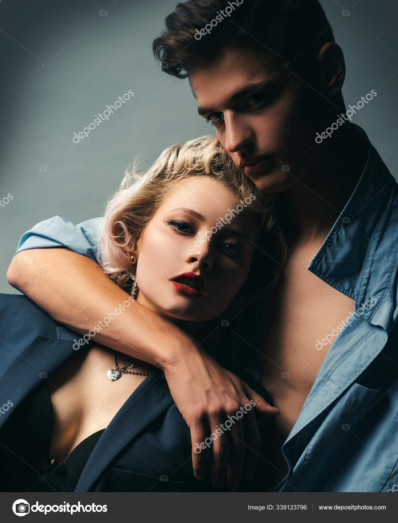Handsome guy is hugging pretty girl with blonde hair. I Love You. Passion sex. Husband and wife get sexual pleasure from hugging. Muscular photo